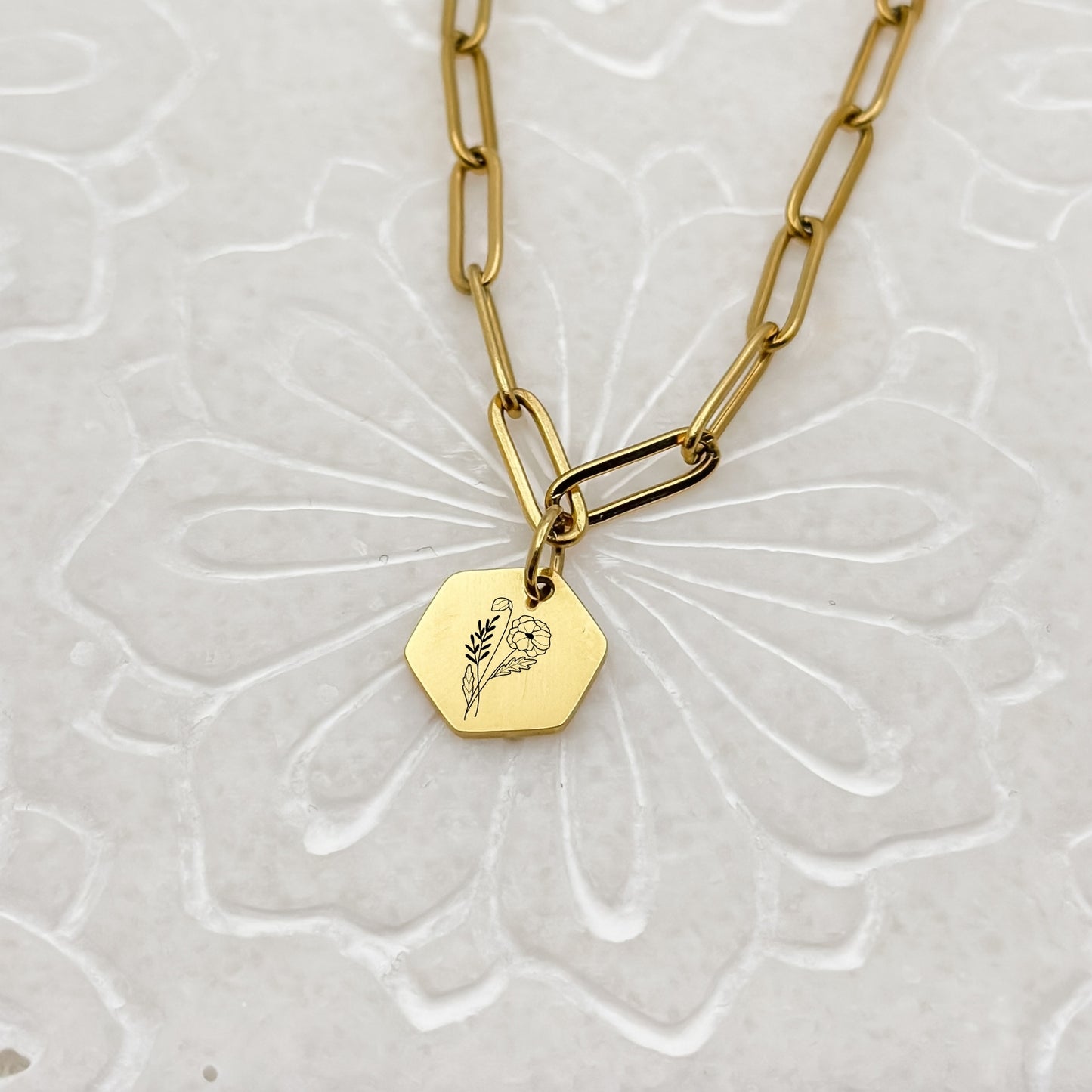 18K PVD Gold hexagon charm necklace with a delicate poppy engraving, symbolizing August birthdays. Hypoallergenic, waterproof, and tarnish-resistant.