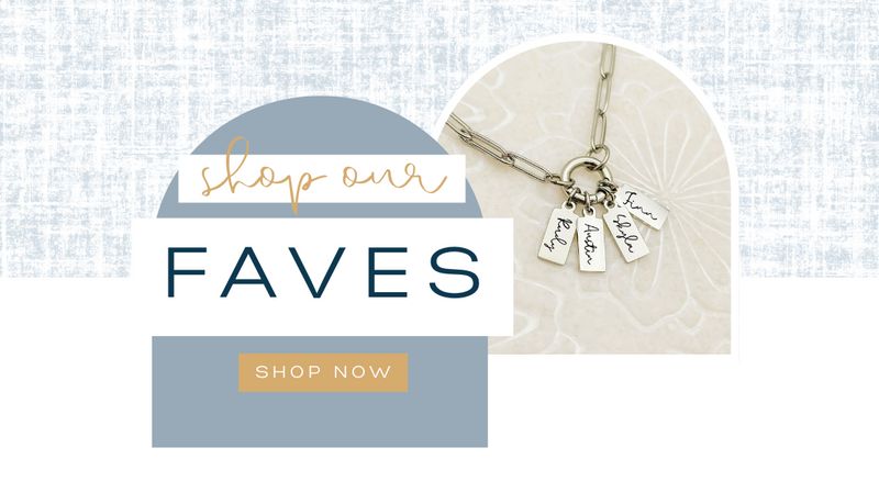 Necklace with charms on a textured white background with 'Shop our FAVES' text.