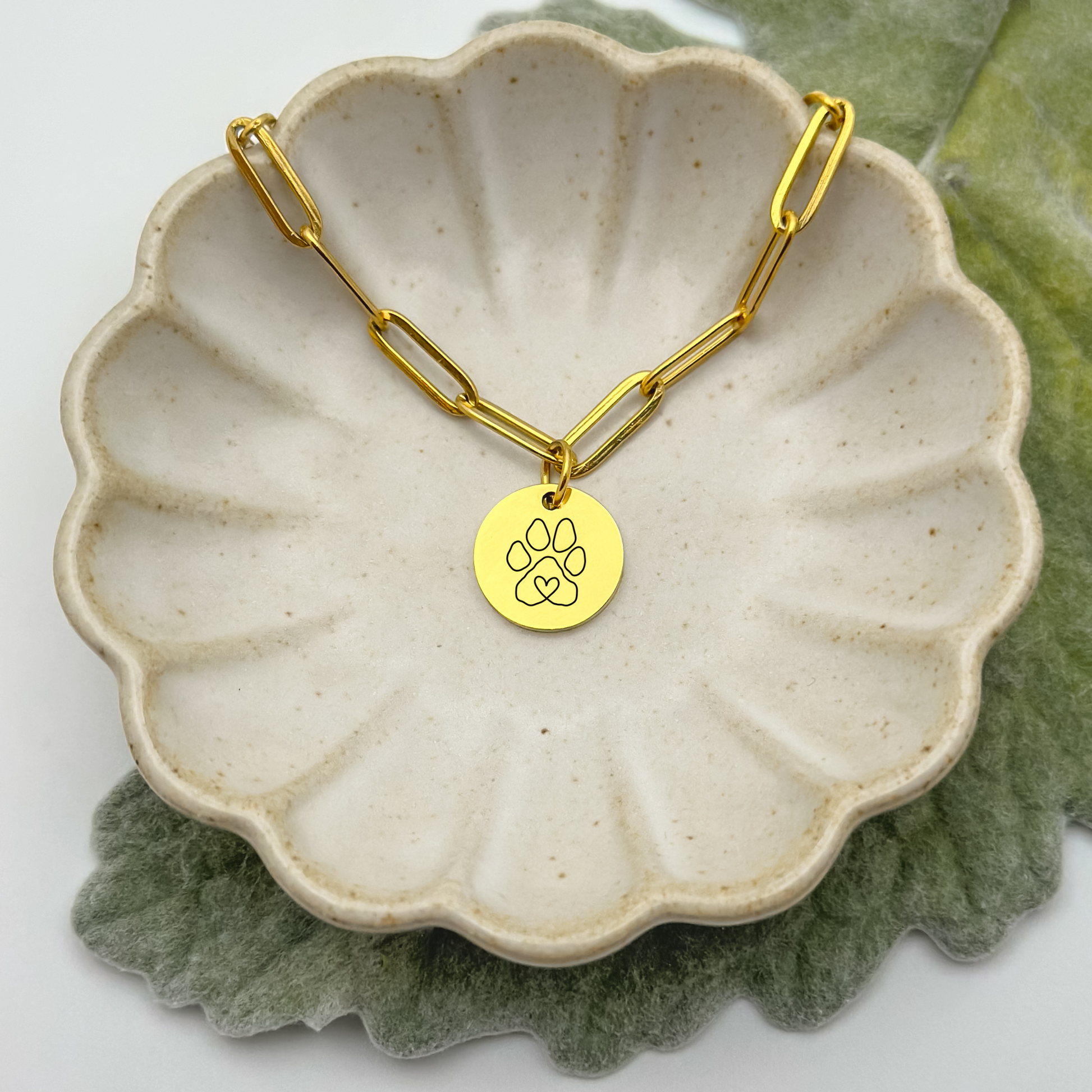 18K PVD Gold circle charm necklace featuring a delicate paw print design on a modern paperclip chain. A minimalist pet lover’s keepsake, crafted from hypoallergenic, waterproof, and tarnish-resistant stainless steel.