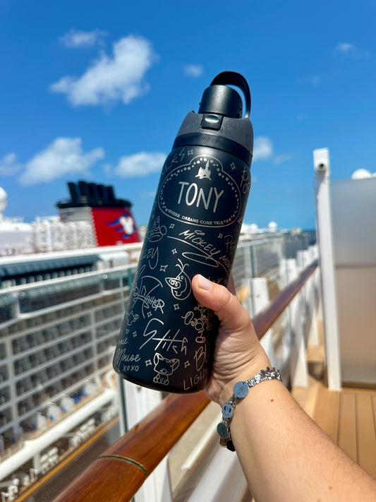 Person holding a black water bottle with 'TONY' branding on a cruise ship deck.