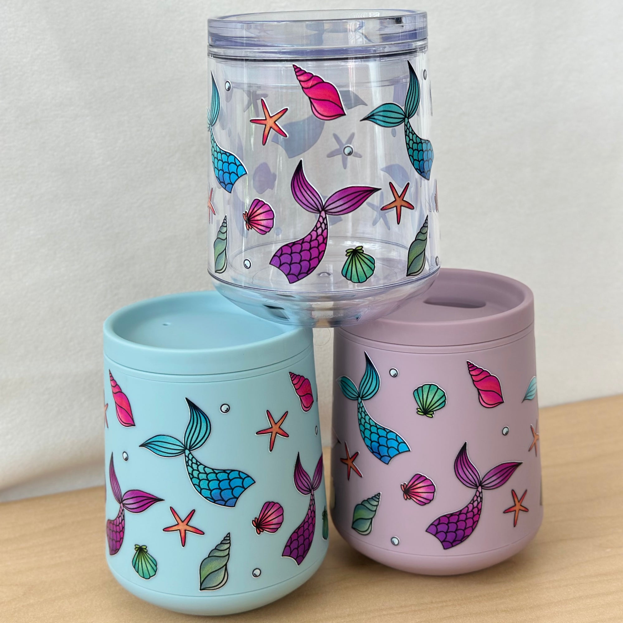 mermaid design on 3 wine tumblers with a wooden base