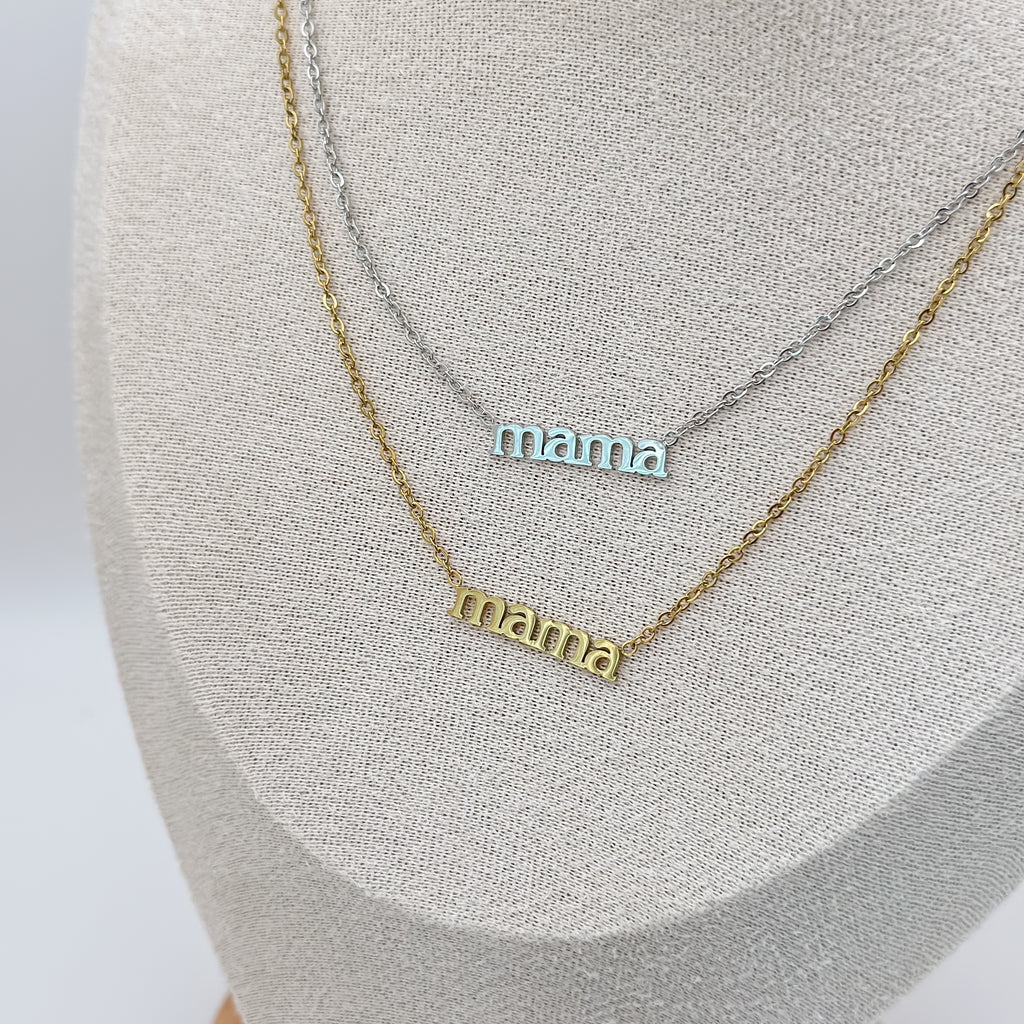 Two 'mama' necklaces on a gray surface