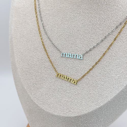 Two 'mama' necklaces on a gray surface