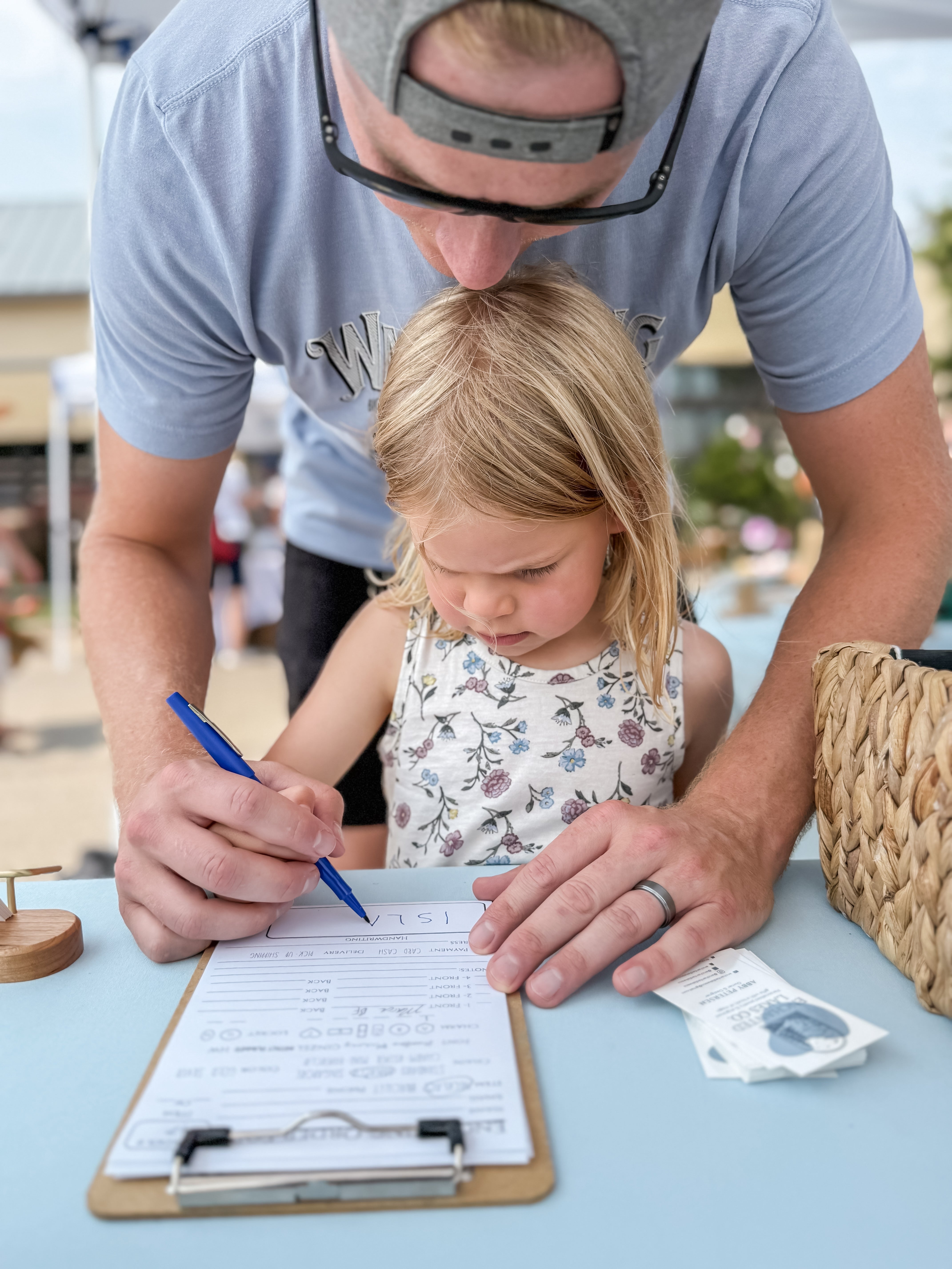 Child's handwriting being captured for a handwritten charm necklace