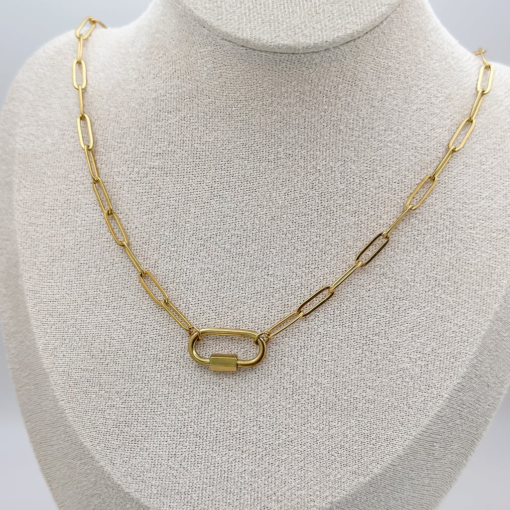 Gold chain necklace on a mannequin bust against a neutral background