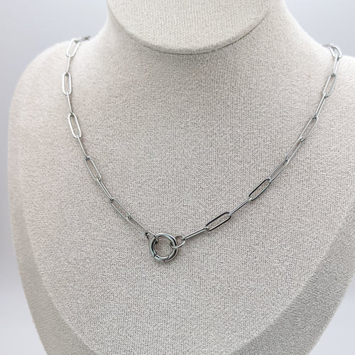 Silver chain necklace on a mannequin bust against a white background